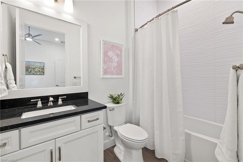 20549 Napa Loop Estero, FL 33928 - Photo 42 of 50 a bathroom with a granite countertop bathtub sink vanity mirror and toilet