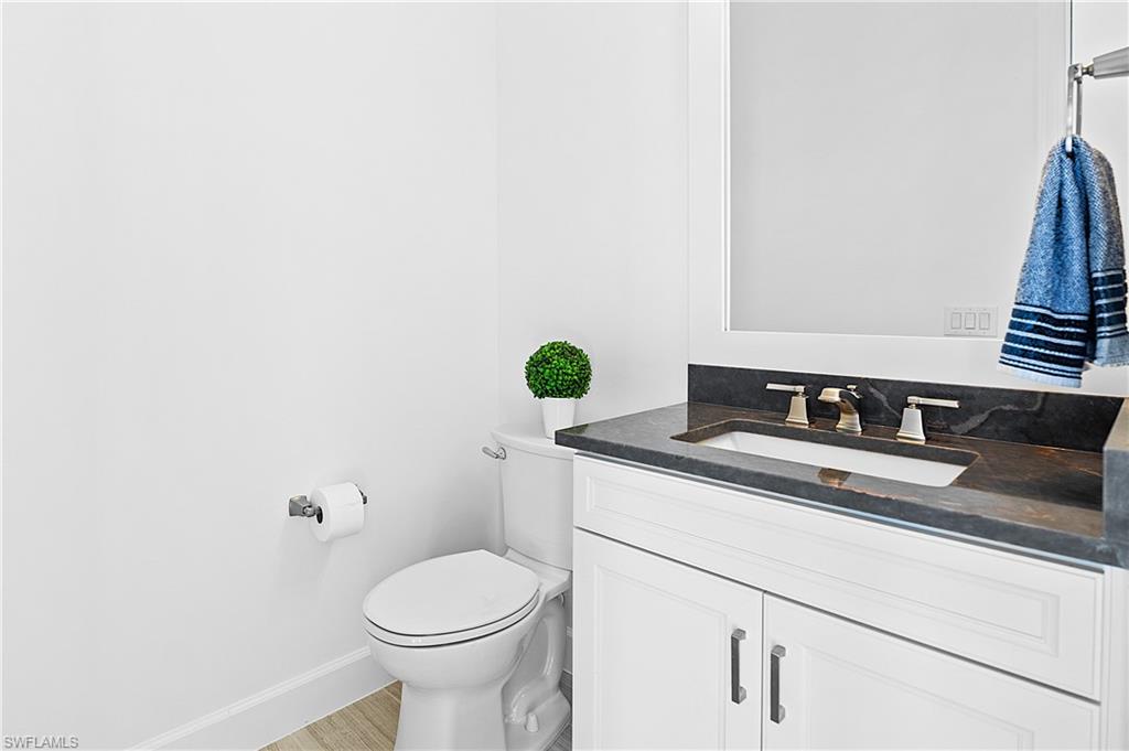 20549 Napa Loop Estero, FL 33928 - Photo 45 of 50 a bathroom with a granite countertop toilet and a sink