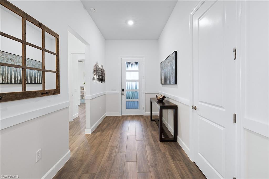 20549 Napa Loop Estero, FL 33928 - Photo 46 of 50 a hallway with wooden floor washer and dryer