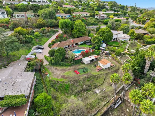 an aerial view of residential houses with outdoor space and street view
