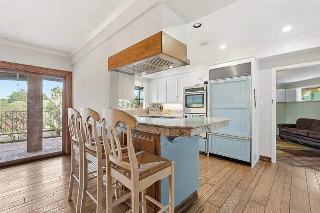 a very nice looking kitchen with granite countertop a large window and stainless steel appliances