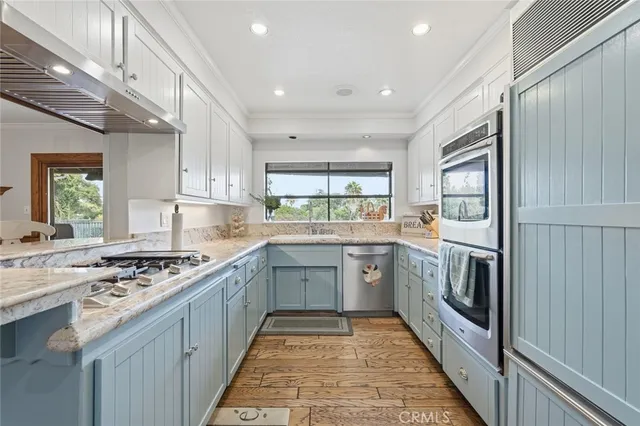 a kitchen with stainless steel appliances granite countertop a stove and a refrigerator