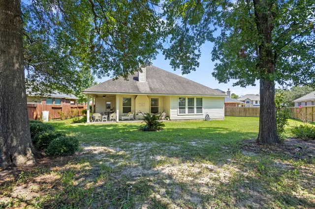 a view of an house with backyard and sitting area