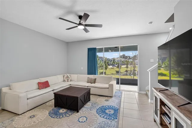 a living room with furniture and kitchen view