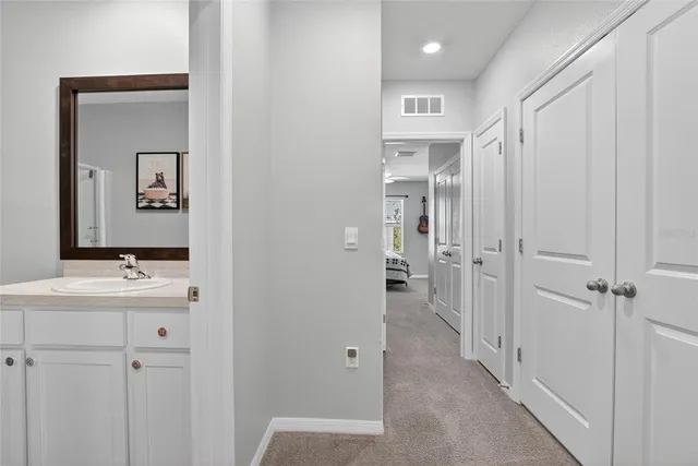 a bedroom with a bed and a lamp