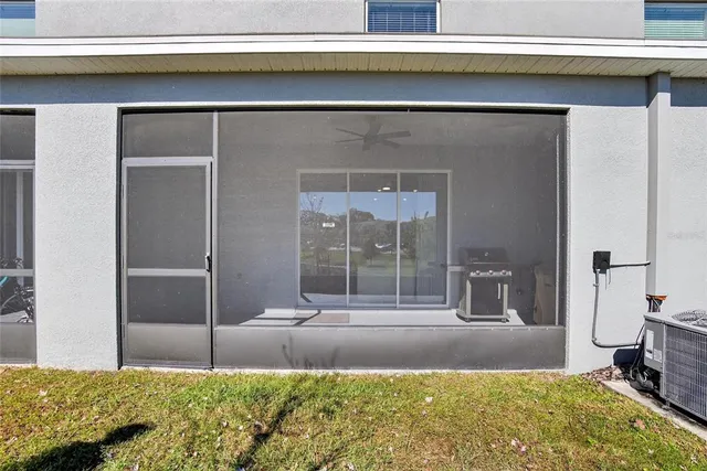 an aerial view of residential houses with outdoor space and trees