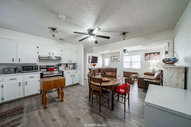 a living room with furniture and kitchen view