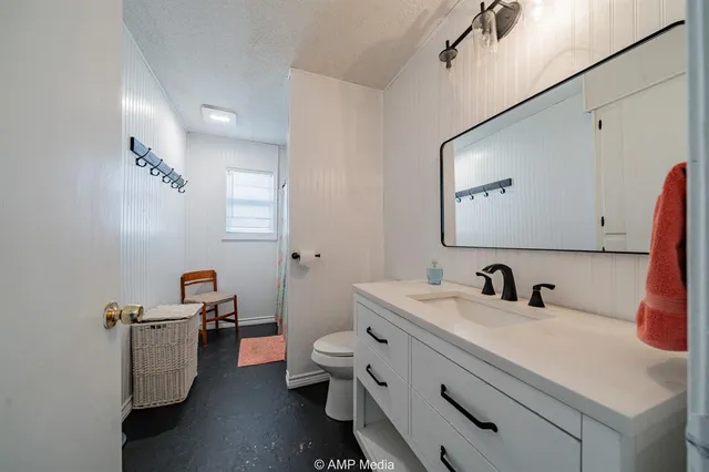 a bathroom with a double vanity sink mirror and toilet
