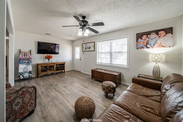 a bedroom with furniture and a flat screen tv