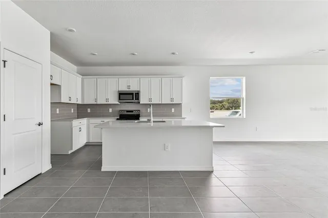 a kitchen with stainless steel appliances a refrigerator sink and cabinets