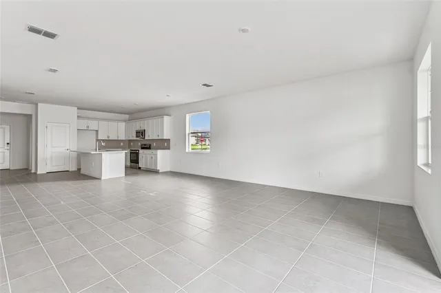 a view of a livingroom with furniture and an empty room