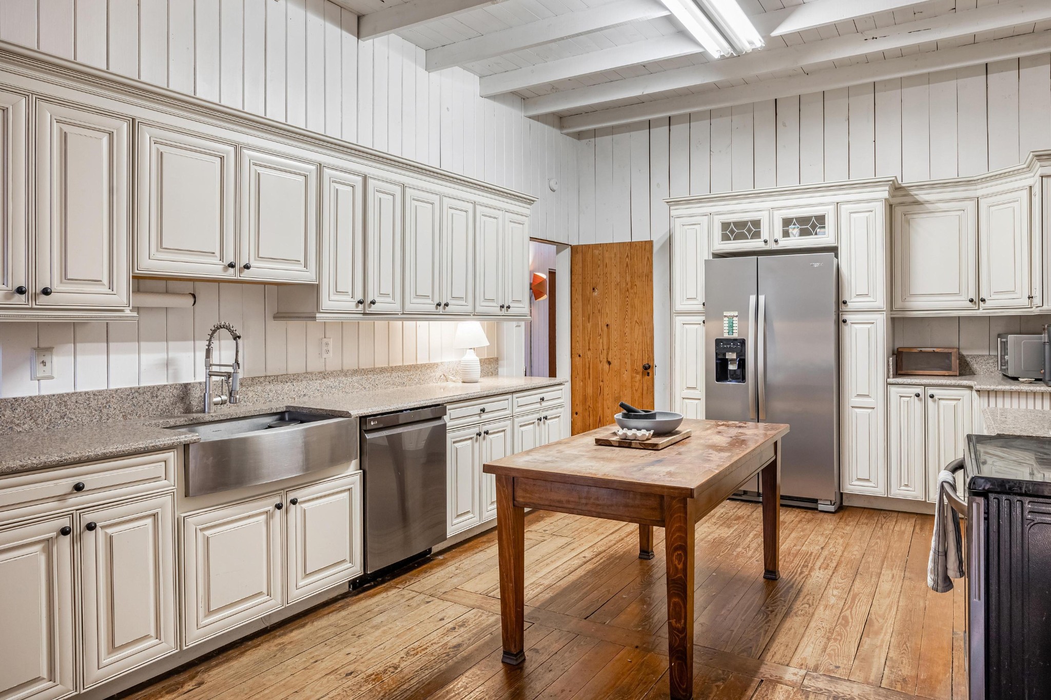 144 Parksville Road Benton, TN 37307 - Photo 20 of 64 a kitchen with stainless steel appliances granite countertop a refrigerator a stove a sink dishwasher and white cabinets with wooden floor