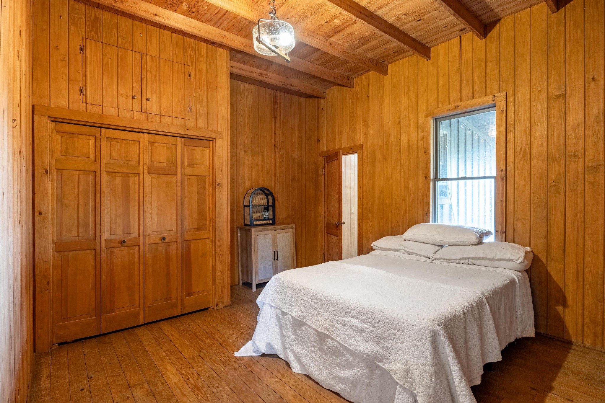 144 Parksville Road Benton, TN 37307 - Photo 27 of 64 a bedroom with a bed and wooden cabinets