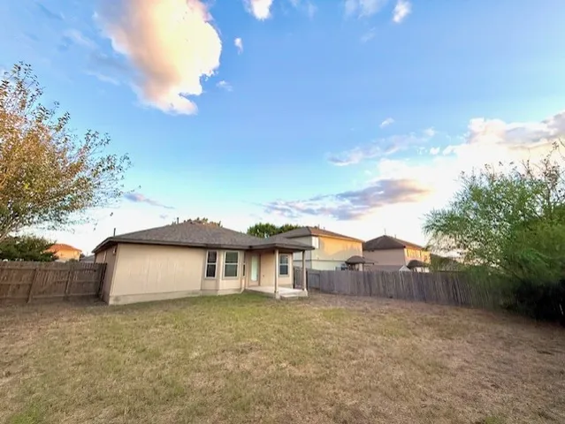 a aerial view of a house with a yard and balcony