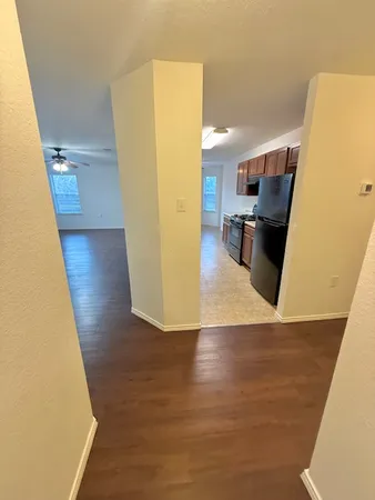 a view of a kitchen from a hallway