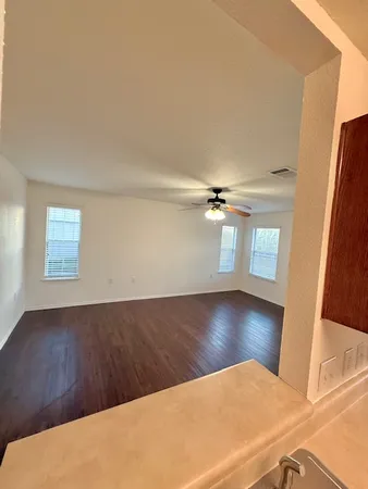 a view of a hallway with wooden floor