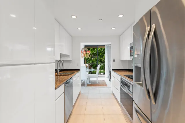 a kitchen with stainless steel appliances a refrigerator sink and stove