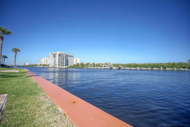 a view of a swimming pool with a bench and a yard