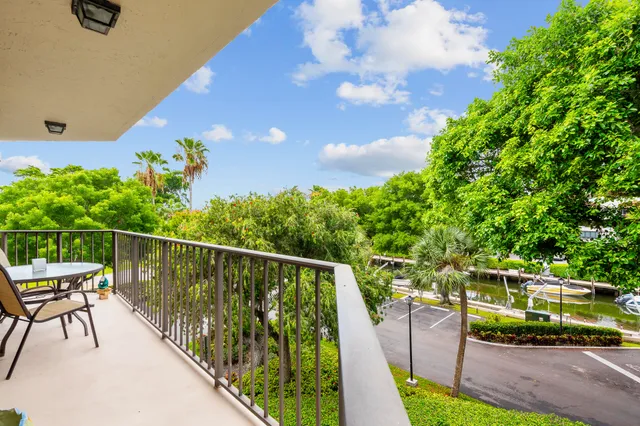 a bedroom with a bed and a large window with wooden floor