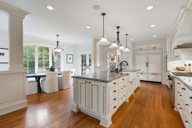a large kitchen with lots of counter space and wooden floor