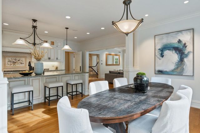 a dining room with furniture and wooden floor