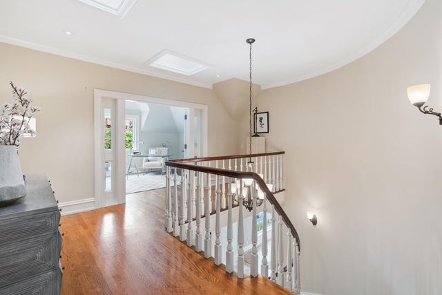 a view of an entryway wooden floor and chandelier