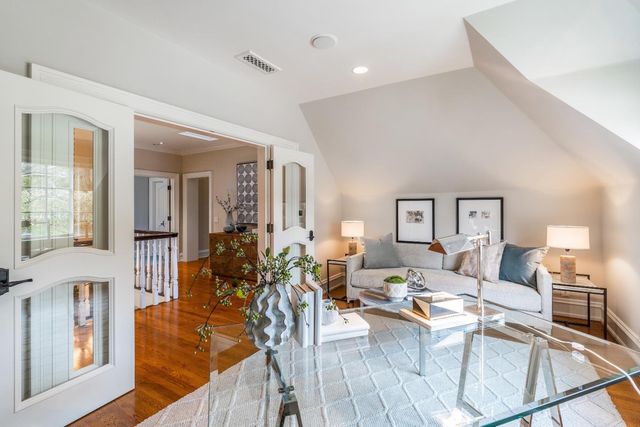 a living room with fireplace furniture and a wooden floor