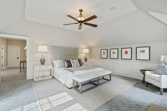 a spacious bedroom with a bed and a couch