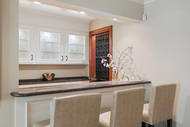 a bathroom with a granite countertop sink a mirror and shower