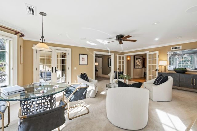a living room with furniture a chandelier and a window