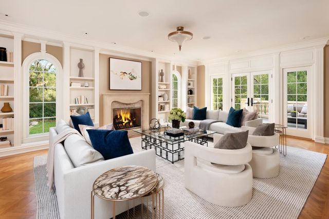 a living room with fireplace furniture and a large window