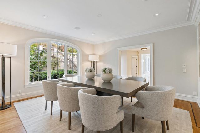 a dining room with furniture a rug and wooden floor