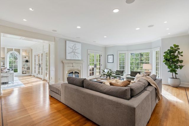 a living room with fireplace furniture and a wooden floor