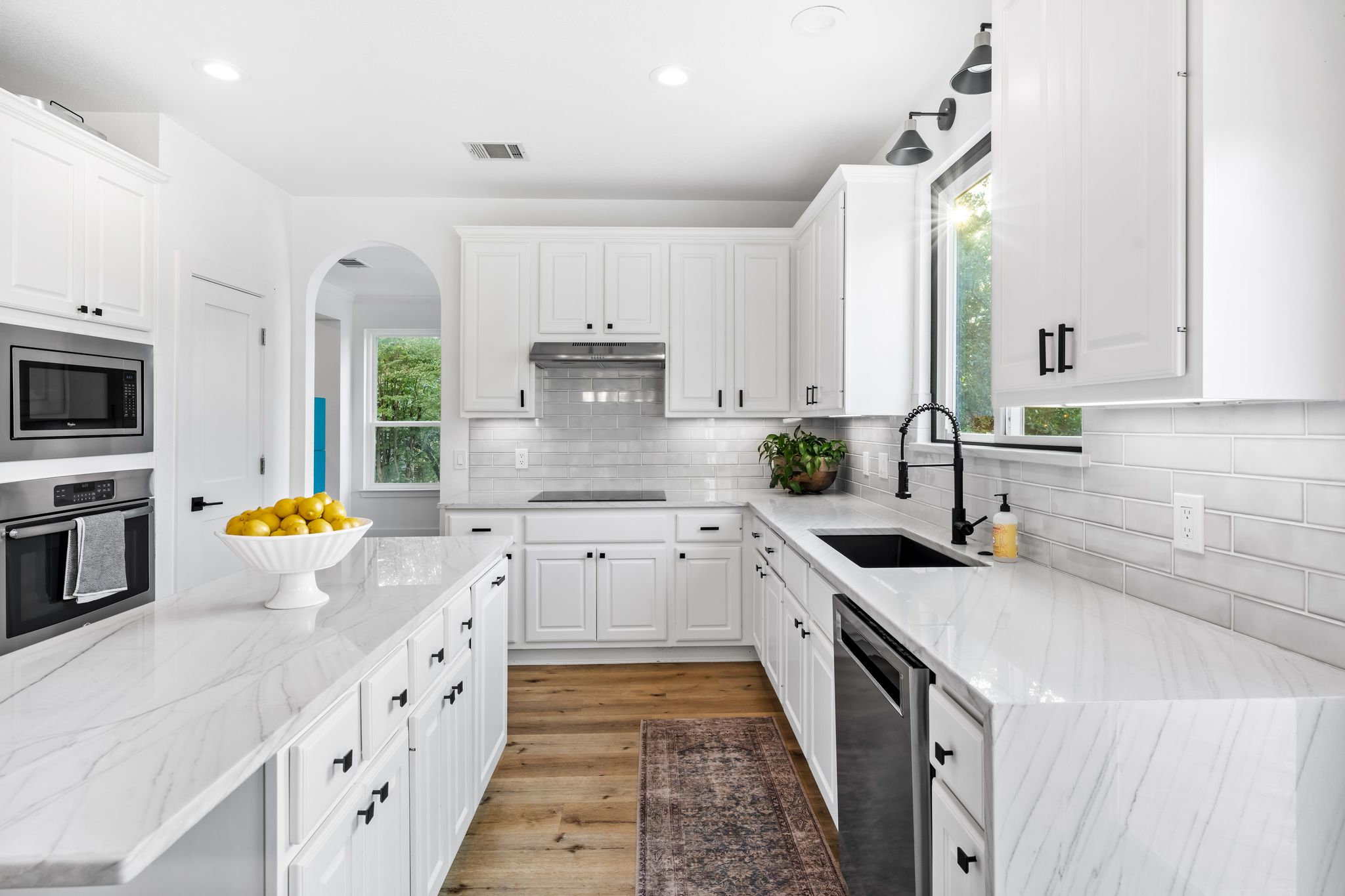 2204 Rimrock Drive Austin, TX 78738 - Photo 8 of 39 Elegant quartz countertops and classic subway tile backsplash define this modern cooking space.