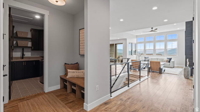 355 East Overlook Loop Hideout, UT 84036 - Photo 22 of 40 Entry hall with wood-finish flooring throughout, with a built-in wooden bench and a utility room featuring dark cabinetry and a patterned floor