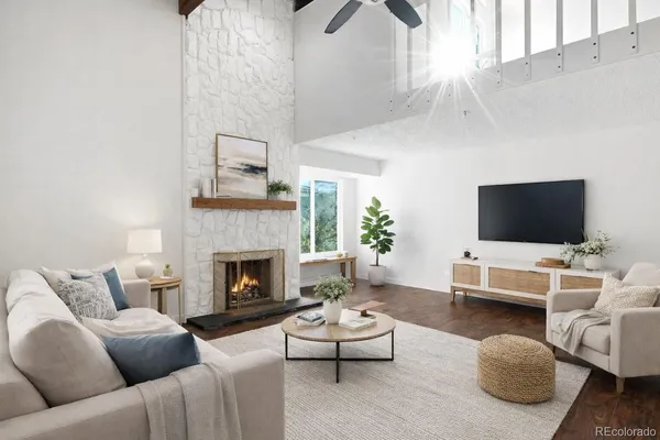 a living room with furniture and a fireplace