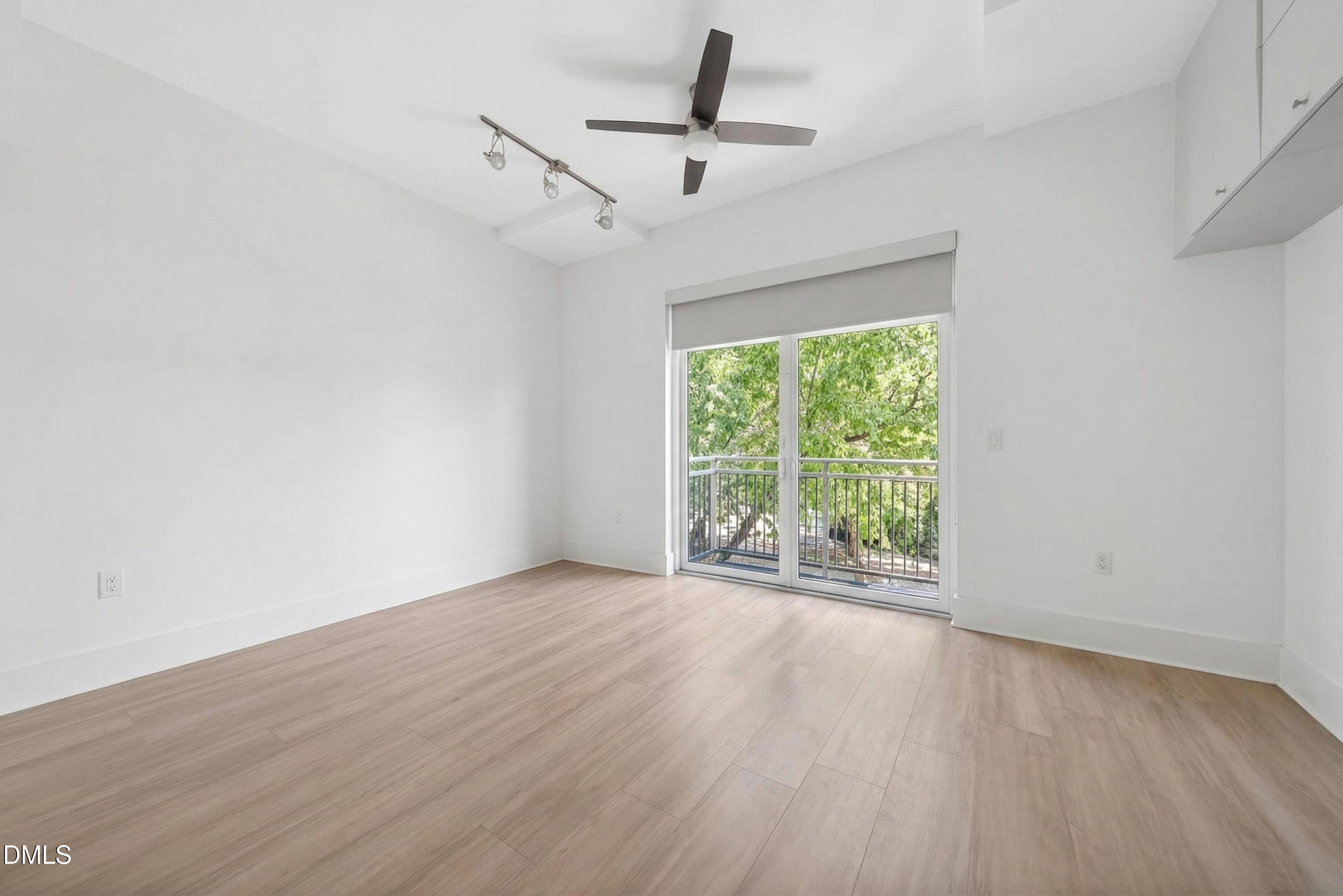 444 South Blount Street, Unit 111 Raleigh, NC 27601 - Photo 12 of 40 a view of empty room with wooden floor and fan