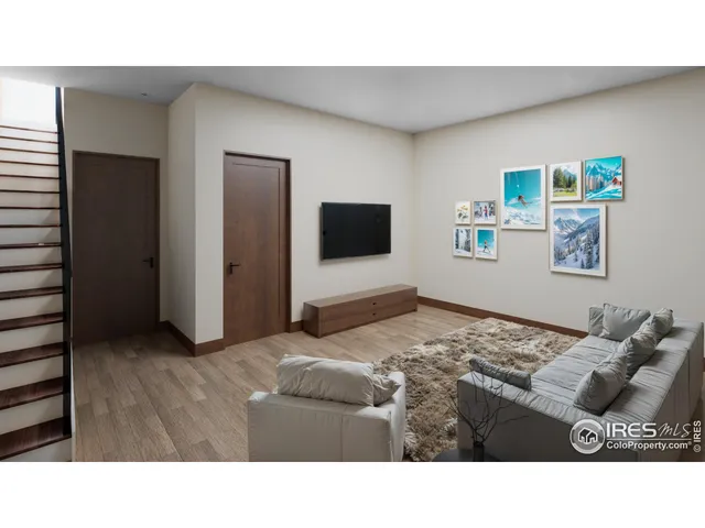 a living room with a bed furniture and a flat screen tv