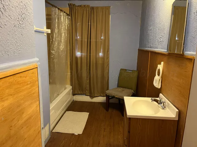 a bathroom with a sink a toilet and tub