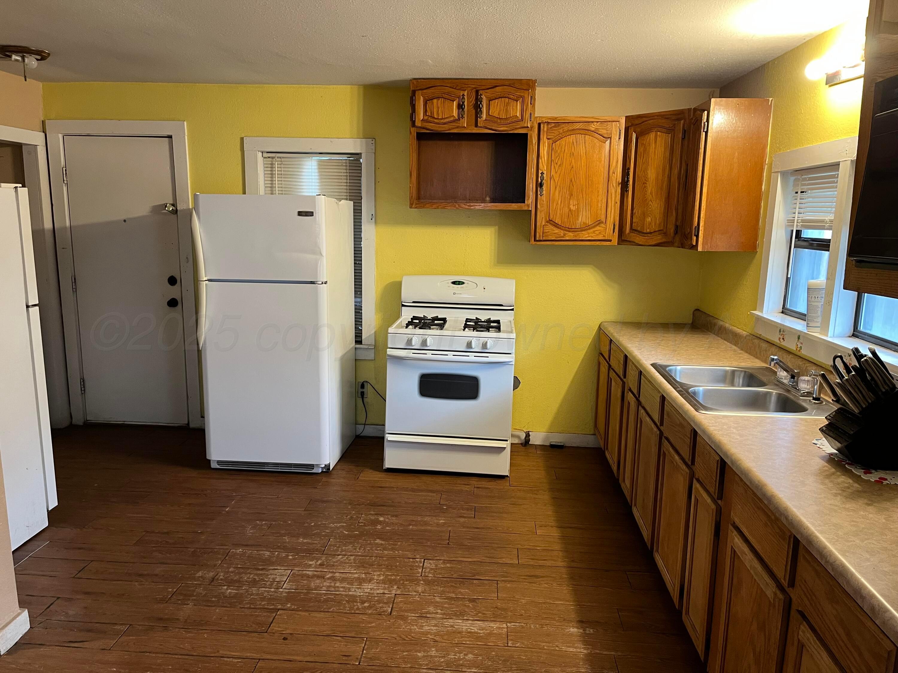 315 North Hedgecoke Street Borger, TX 79007 - Photo 18 of 24 a kitchen with a refrigerator sink and stove