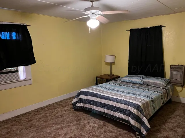 a bedroom with a bed and a wall painting