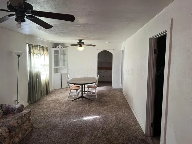 a view of a hallway with entryway wooden floor and a livingroom view
