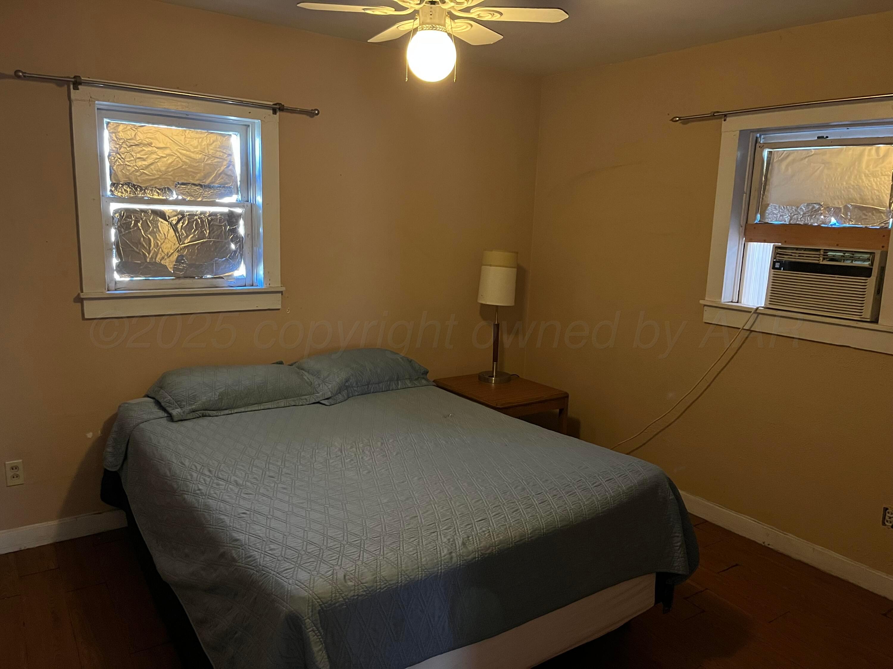 315 North Hedgecoke Street Borger, TX 79007 - Photo 21 of 24 a bed sitting in a bedroom next to a window