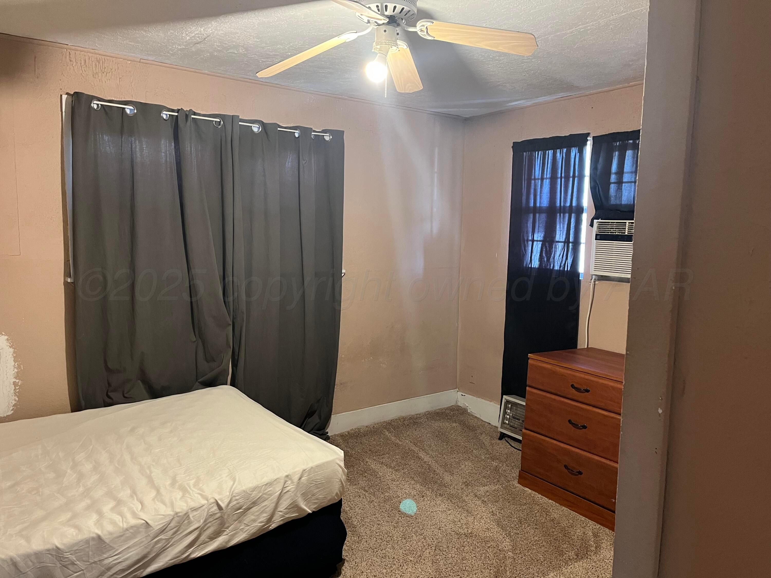 315 North Hedgecoke Street Borger, TX 79007 - Photo 4 of 24 a bedroom with a bed and a dresser