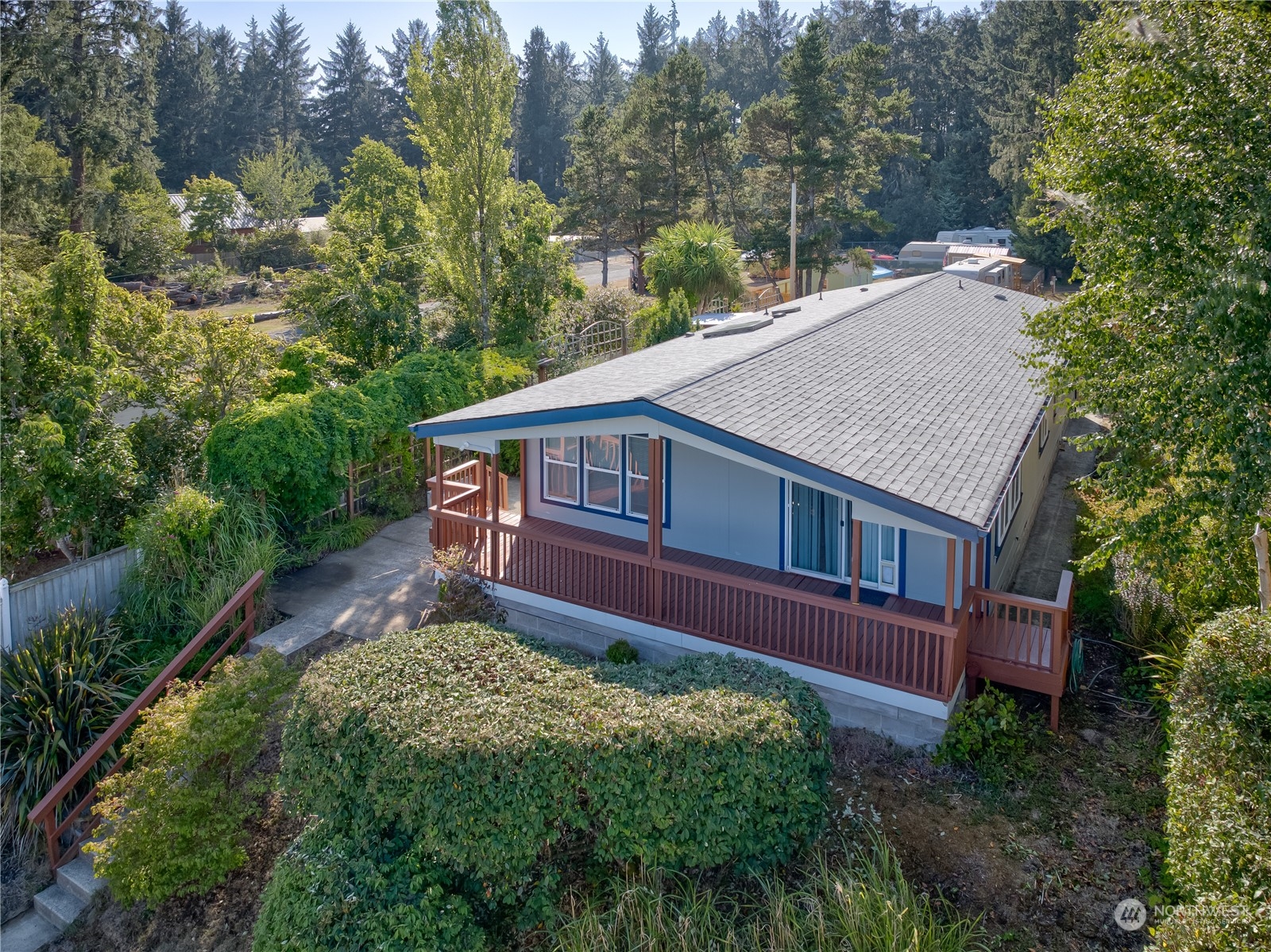 26507 Sandridge Road Nahcotta, WA 98640 - Photo 17 of 40 a view of a house with a small yard plants and large trees