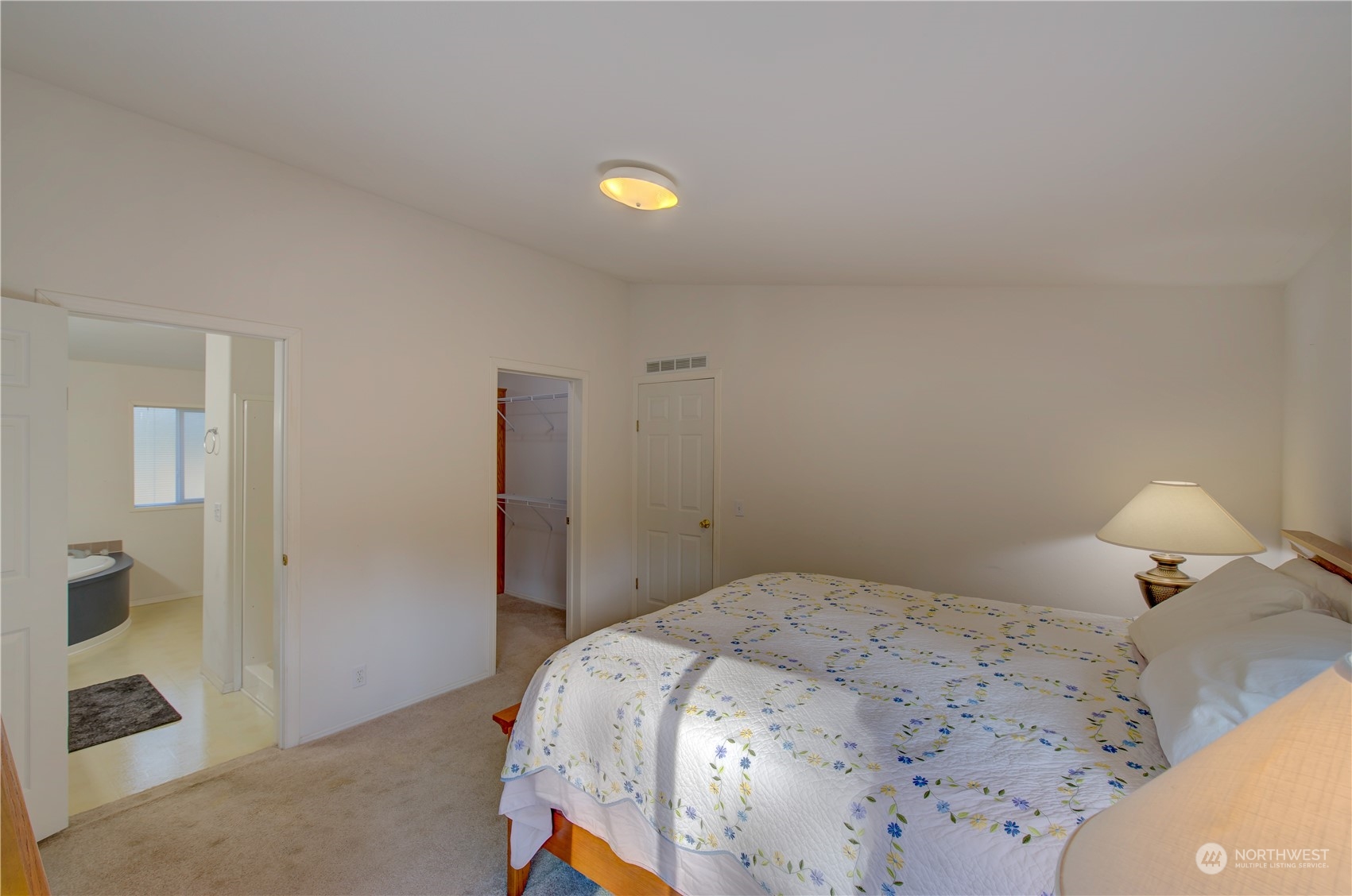 26507 Sandridge Road Nahcotta, WA 98640 - Photo 31 of 40 a bedroom with a bed and a lamp