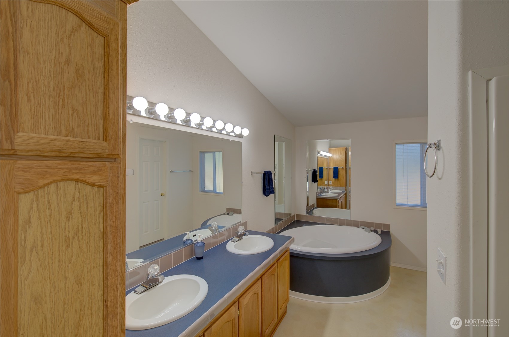 26507 Sandridge Road Nahcotta, WA 98640 - Photo 33 of 40 a bathroom with a granite countertop sink a toilet and mirror