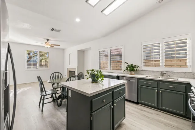 a kitchen with a sink stove and dining table