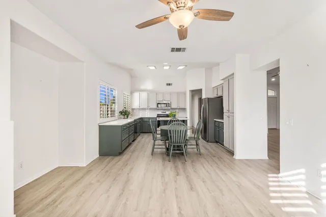 a view of an empty room with a fireplace and a window