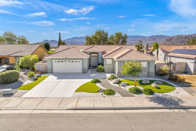 a front view of house with yard swimming pool and outdoor seating
